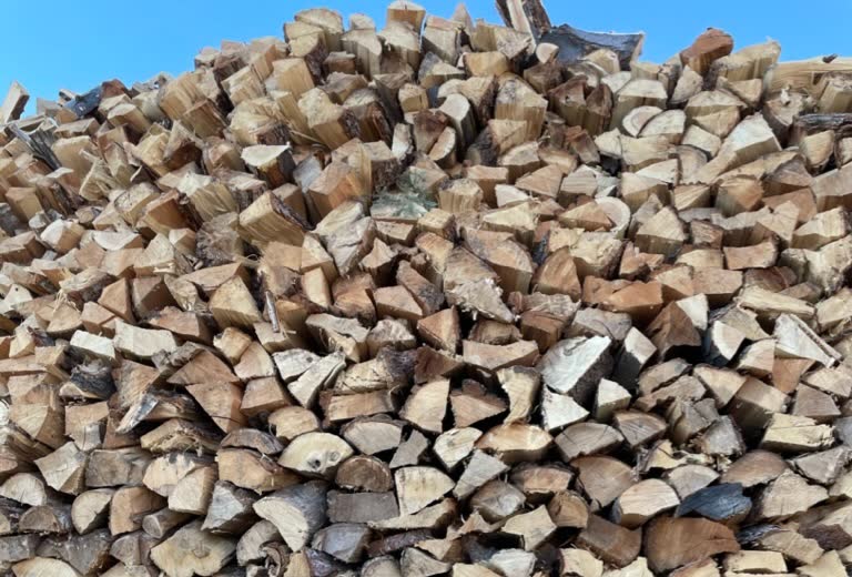 Large stack of split seasoned firewood